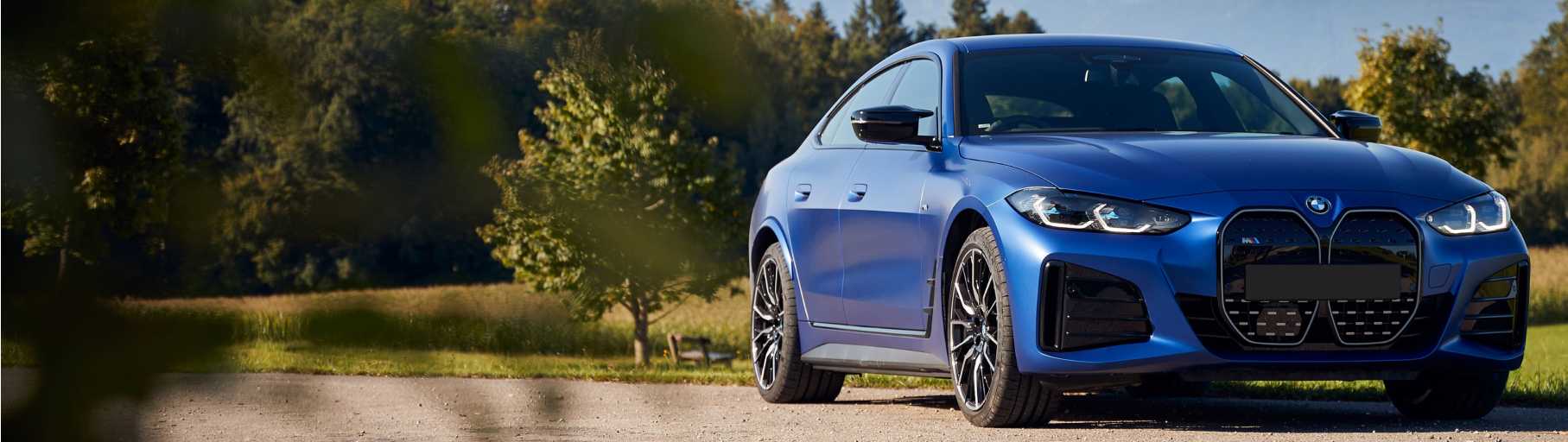 Blue BMW car on a country road